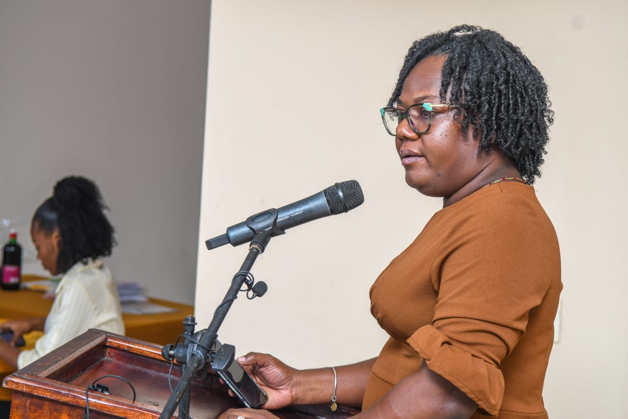 The trainer makes an empowering gesture to everyone present.